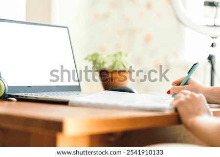 Creating a Productive Study Environment at Home, women's hands with a notebook and pen at the table
