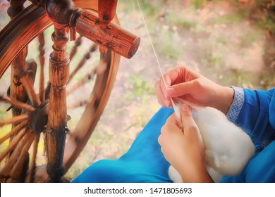 Creating yarn threads, close-up. Spinning wheel in nature, rustic style - Powered by Shutterstock