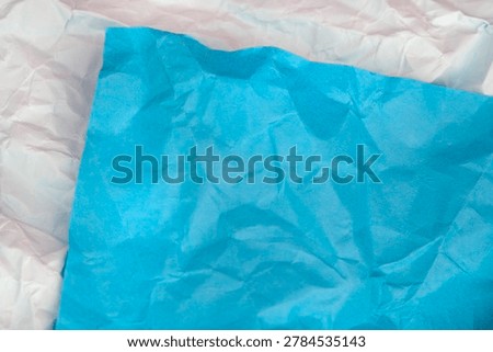 Creative abstract background featuring layered blue and white crumpled paper textures. Modern artistic backdrop suitable for design, stationery and creative copy space concepts.