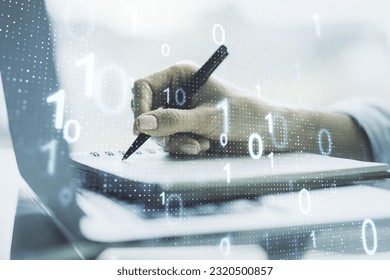 Creative abstract binary code sketch and hand writing in notepad on background with laptop, hacking and matrix concept. Multiexposure