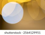 A creative abstract bokeh effect with overlapping circles of warm yellow and cool blue light, creating a harmonious and visually pleasing pattern