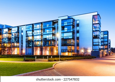 Creative abstract house building and city construction concept: evening outdoor urban view of modern real estate homes