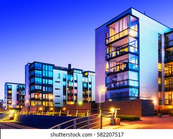 Creative Abstract House Building And City Construction Concept: Evening Outdoor Urban View Of Modern Real Estate Homes