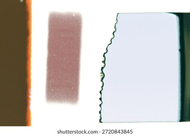 A creative abstract image featuring vertical film strips and torn edges in warm and cool tones. This stock photo conveys texture, light, and modern artistic composition suitable for design projects.