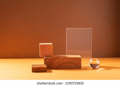 Creative abstract podium from wooden figures and glass, against a brown background with hard light - Shutterstock ID 2190725835