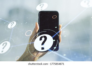 Creative Abstract Question Mark Hologram And Hand With Mobile Phone On Background, Future Technology Concept. Multi Exposure