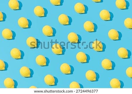 Creative abstract summer lemon pattern flat lay on pastel blue background minimalism