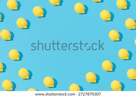 Creative abstract summer lemon pattern flat lay on pastel blue background minimalism with copy space