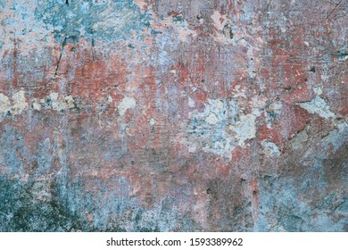 Creative abstract texture background. Beautiful turquoise, red and grey grunge rough artistic old stone wall with cracks and scratches. Copy space	