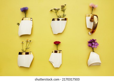 Creative Aesthetic Broken Cup's Pieces With Wildflowers, Miniature Flower Pots. Creative Conceptual Home Decorations Idea. House Plants, Growth, Hope, Cozy Home Concept. Plant Aesthetic