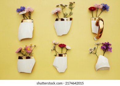 Creative Aesthetic Broken Cup's Pieces With Wildflowers, Miniature Flower Pots. Creative Conceptual Home Decorations Idea. House Plants, Growth, Hope, Cozy Home Concept. Plant Aesthetic