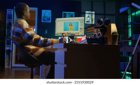 Creative african american graphic designer editing images on dual monitors, showcasing talent and dedication to the digital design field in a well organized home workspace. Camera B. - Powered by Shutterstock