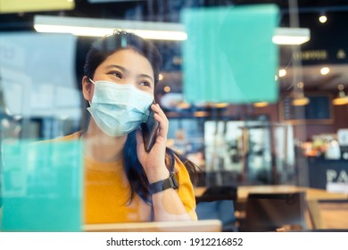 Creative Agency Asian Female Casual Cloth And Face Mask Protection Conversation With Smartphone Freelance Working With Laptop At Coworking Area Office Space With Freshness With Blur Office Background