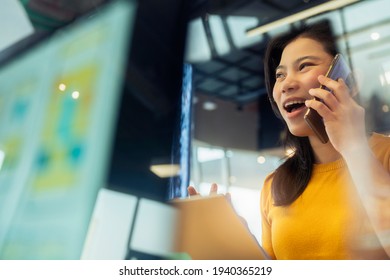 Creative Agency Asian Female Casual Cloth Conversation With Smartphone Freelance Working Wuth Laptop At Coworking Area Office Space With Freshness With Blur Office Background