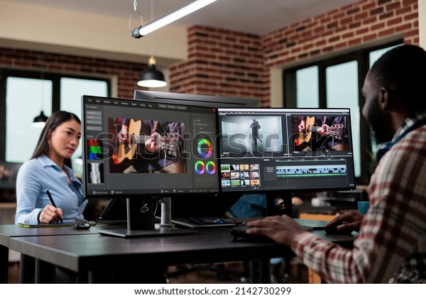 Creative agency professional employee editing\
movie footage using specialized software while in post production\
house. Video editor specialist improving film montage visual\
quality.
