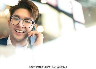 Creative Agency Smart Glasses Asian Male Formal Cloth Conversation With Smartphone Freelance Working With Laptop At Coworking Area Office Space With Freshness With Blur Office Background