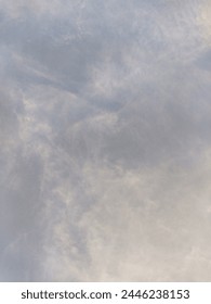 Creative and angelic cirrus clouds float in the dramatic golden hour