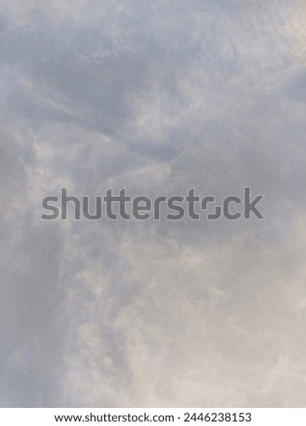 Creative and angelic cirrus clouds float in the dramatic golden hour