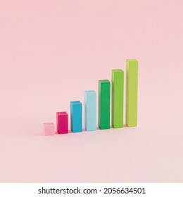 A Creative Arrangement Of Statistical Data Representation Made Of Wooden Cuboids On A Pink Background. Minimal Data Or Development Concept. Statistics, Analysis And Diagram Inspiration.