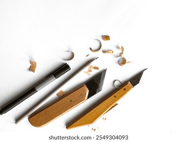 Creative art tools. Wood carving knives and pen on white background - Powered by Shutterstock