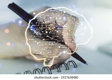 Creative artificial Intelligence concept with human brain sketch and man hand writing in diary on background. Double exposure