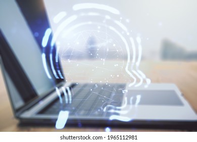 Creative artificial Intelligence concept with human head hologram on modern laptop background. Multiexposure