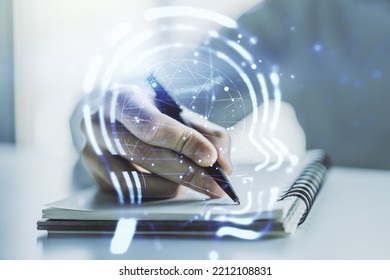 Creative artificial Intelligence concept with human head hologram and man hand writing in notebook on background. Multiexposure