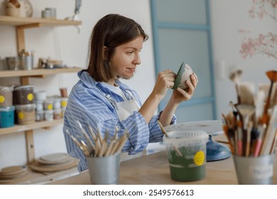 A Creative Artist in a Pottery Studio Skillfully Crafting a Truly Unique Ceramic Piece - Powered by Shutterstock