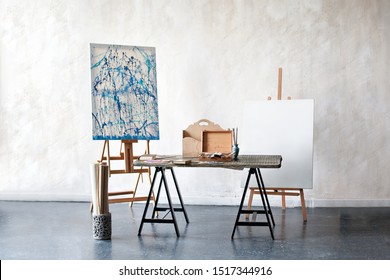 Creative Artist Workplace No People Hobbies. Painting Studio Of A Freelance Artist. Easel, Canvas, Brushes, Pencils, Paints With Albums On The Table. The Interior In The Studio Of The Artist, Workshop