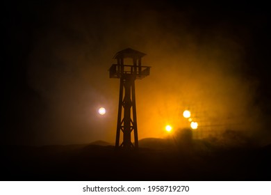 Creative artwork decoration. War concept. Silhouette of army watchtower at night. Selective focus