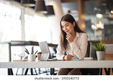 Creative Asian Young Woman Working On Laptop In Her Studio