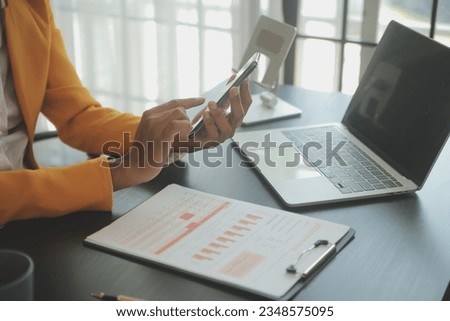 Creative Asian young woman working on laptop in her studio