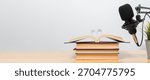Creative audiobook narration setup featuring an open book with heart shaped pages near a studio microphone, symbolizing storytelling, learning, education, romance and digital audio creation.