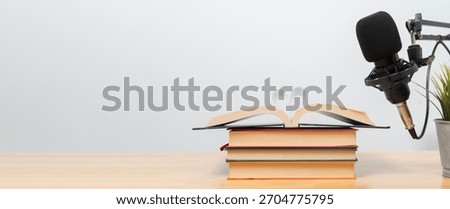 Creative audiobook narration setup featuring an open book with heart shaped pages near a studio microphone, symbolizing storytelling, learning, education, romance and digital audio creation.
