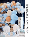 Creative baby boy shower, birthday or baptism balloon decoration on table.