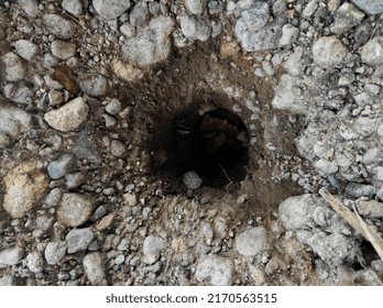 Creative background of a hole in the ground.