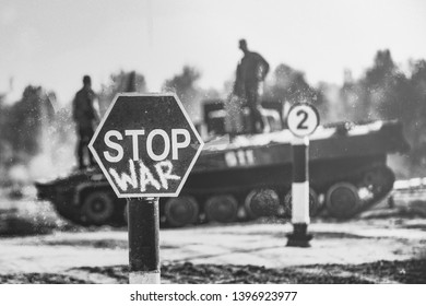 Creative Badge - Stop Wars. Concept - no war, stop military operations, world peace. Stop war sign on the background of military equipment.