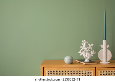 Creative Bedroom Interior Composition With Rattan Commode, Modern Home Decorations And Personal Accessories. Eucalyptus Green Wall. Template. Copy Space.