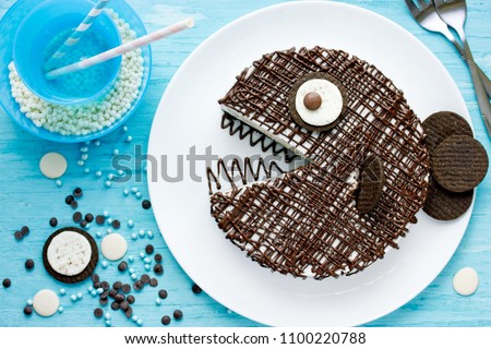 Creative birthday cake for kids, chocolate fish cake on a plate top view