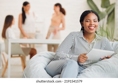 Creative Black Woman On Social Media, With Tablet And Checking Online While On A Work Break. Happy Young Lady Boss Of Ecommerce Startup, Relaxing Before A Business Meeting Business With Her Girl