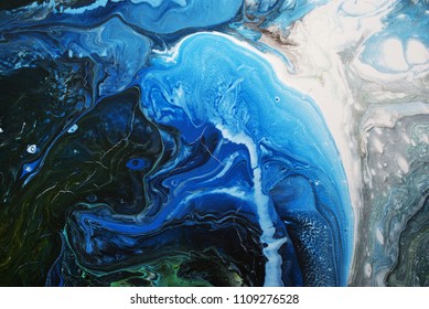 Creative blue abstract hand painted background, wallpaper, texture, close-up fragment of fluid acrylic painting. Cracked surface. Contemporary art.