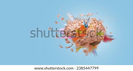 Creative brain explodes with paint splashes on blue background, concept. Think differently and brainstorm, a creative idea. The mind and the generator of creativity
