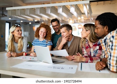 Creative brainstorming. Happy business people, designers, architects working as a team in office - Shutterstock ID 1902728494