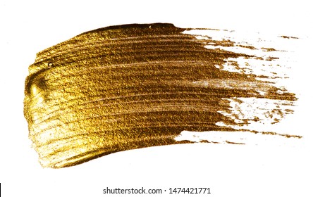 Creative brushstrokes of gold paint isolated on a white background. Gold paint texture. Smears of cosmetics, blush, highlighter, eye shadow, lipstick.