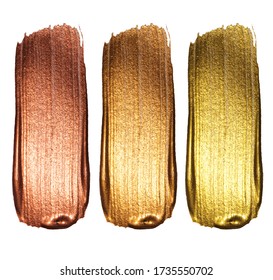 Creative brushstrokes of gold paint isolated on a white background. Gold paint texture.Acrylic gold paint. Smears of cosmetics, blush, highlighter, eye shadow, lipstick.