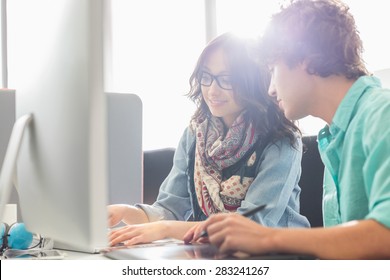 Creative business colleagues using desktop computer in office - Shutterstock ID 283241267
