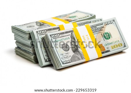 Creative business finance making money concept - stack of bundles of 100 US dollars 2013 edition banknotes (bills) isolated on white