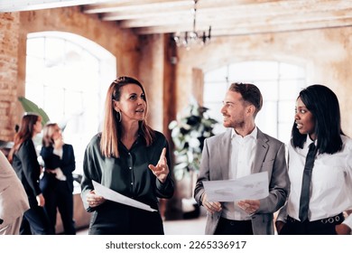 Creative Business Lifestyle: Team of Three Colleagues Discussing and Building Good Vibes in an Office - Selective focus on man