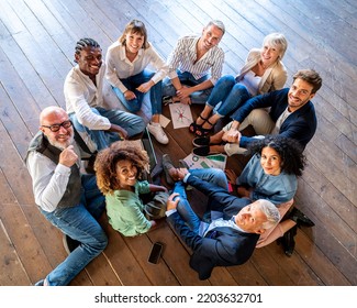 Creative business people having a team building session, mixed age range group of designer working together for strategy, smiling colleagues teamwork - Shutterstock ID 2203632701