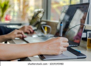 A creative business writes something on notepad. To check the information during lunch break in the coffee room. - Powered by Shutterstock